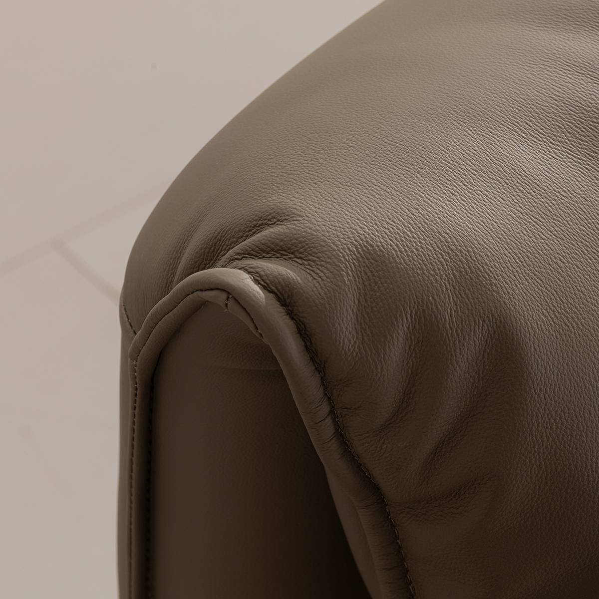 Detail shot of the leather texture and stitching on the headboard