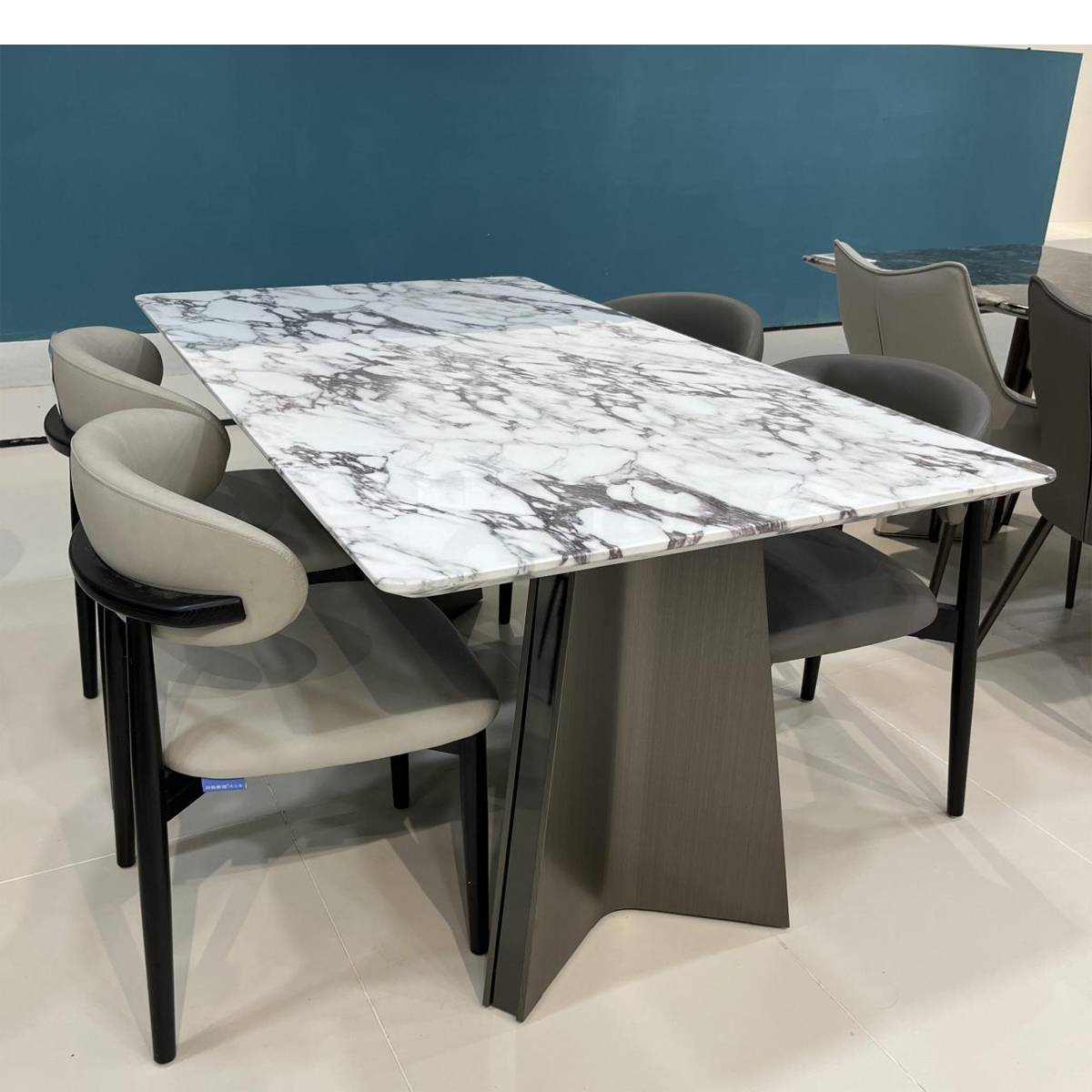 Side view of the marble dining table with grey chairs