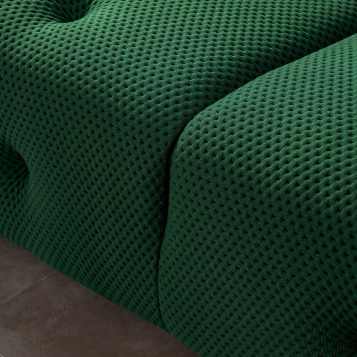 Close-up of green tufted sofa fabric texture