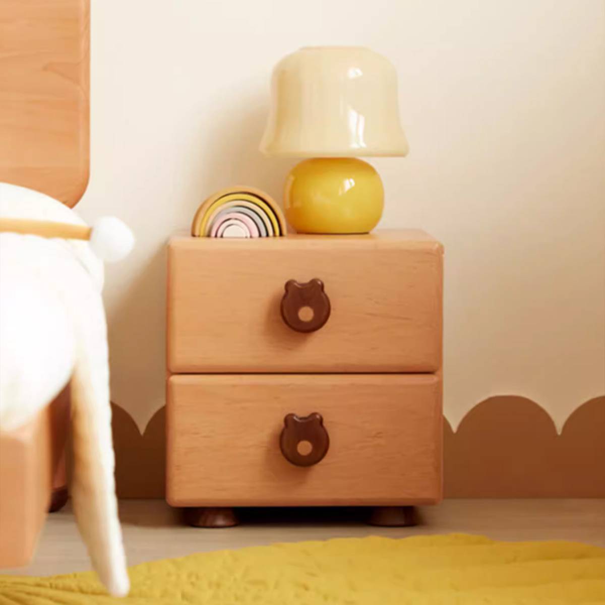 Front view of the wooden bedside table showing two drawers with bear handles