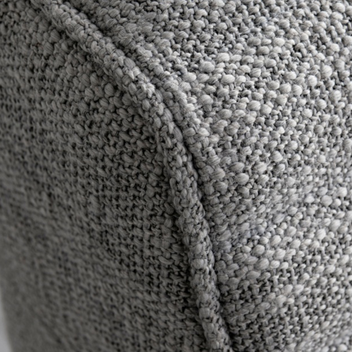 Close-up detail of the grey textured fabric on the headboard