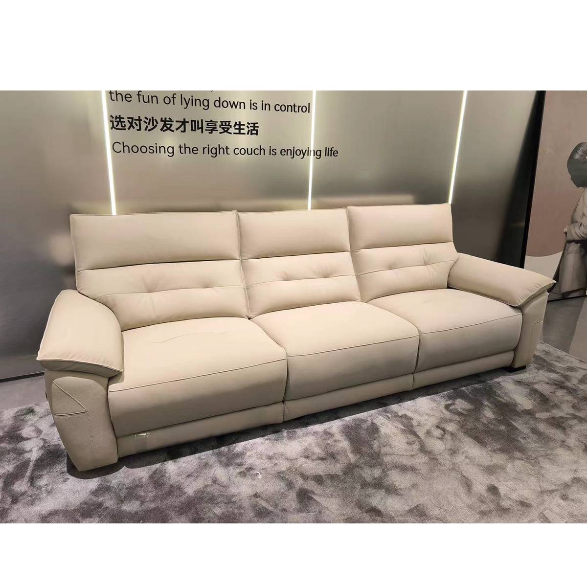 Showroom view of the sofa with promotional text on the wall