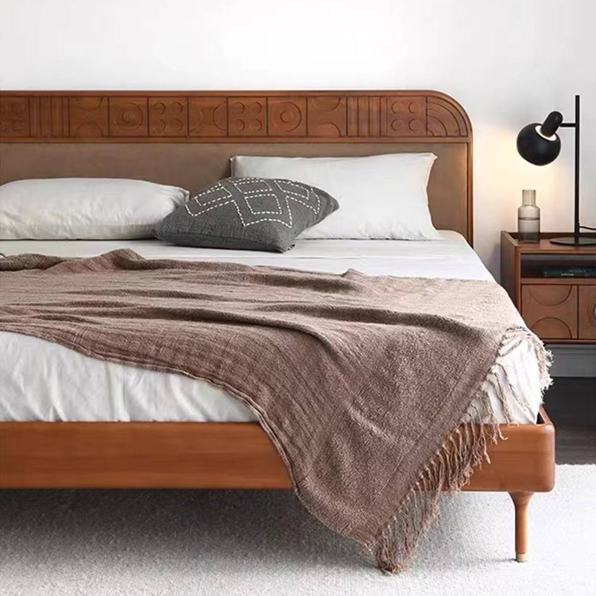 Close-up of the bed with throw blanket and pillows