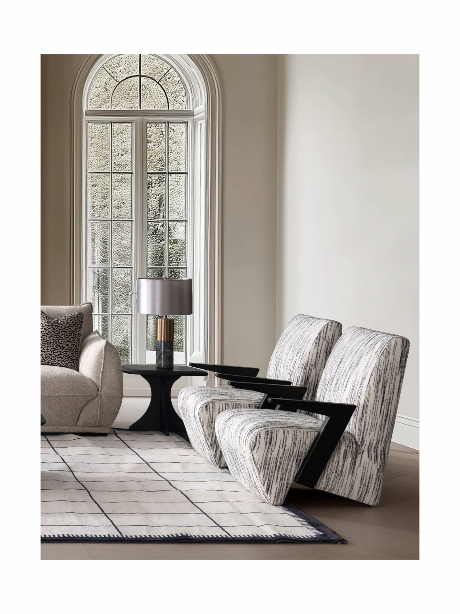 Two lounge chairs placed in a living room setting near a window