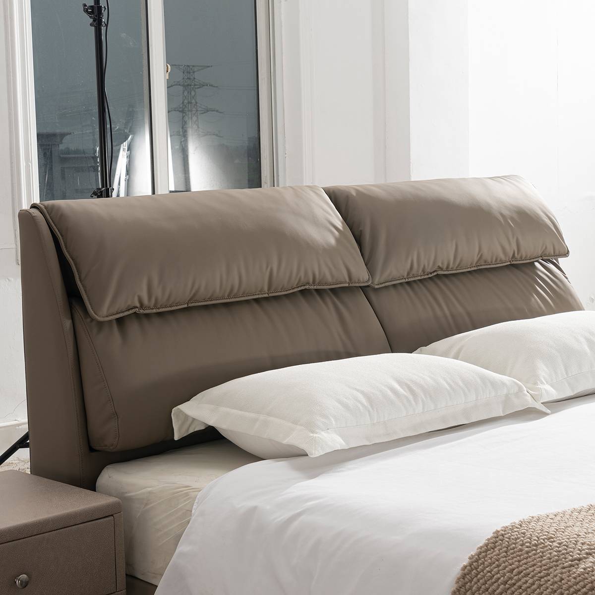 Close-up of the padded headboard and pillows