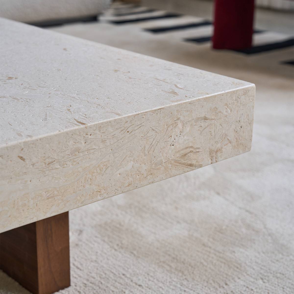 Close-up detail of the natural stone coffee table edge showing fossil textures