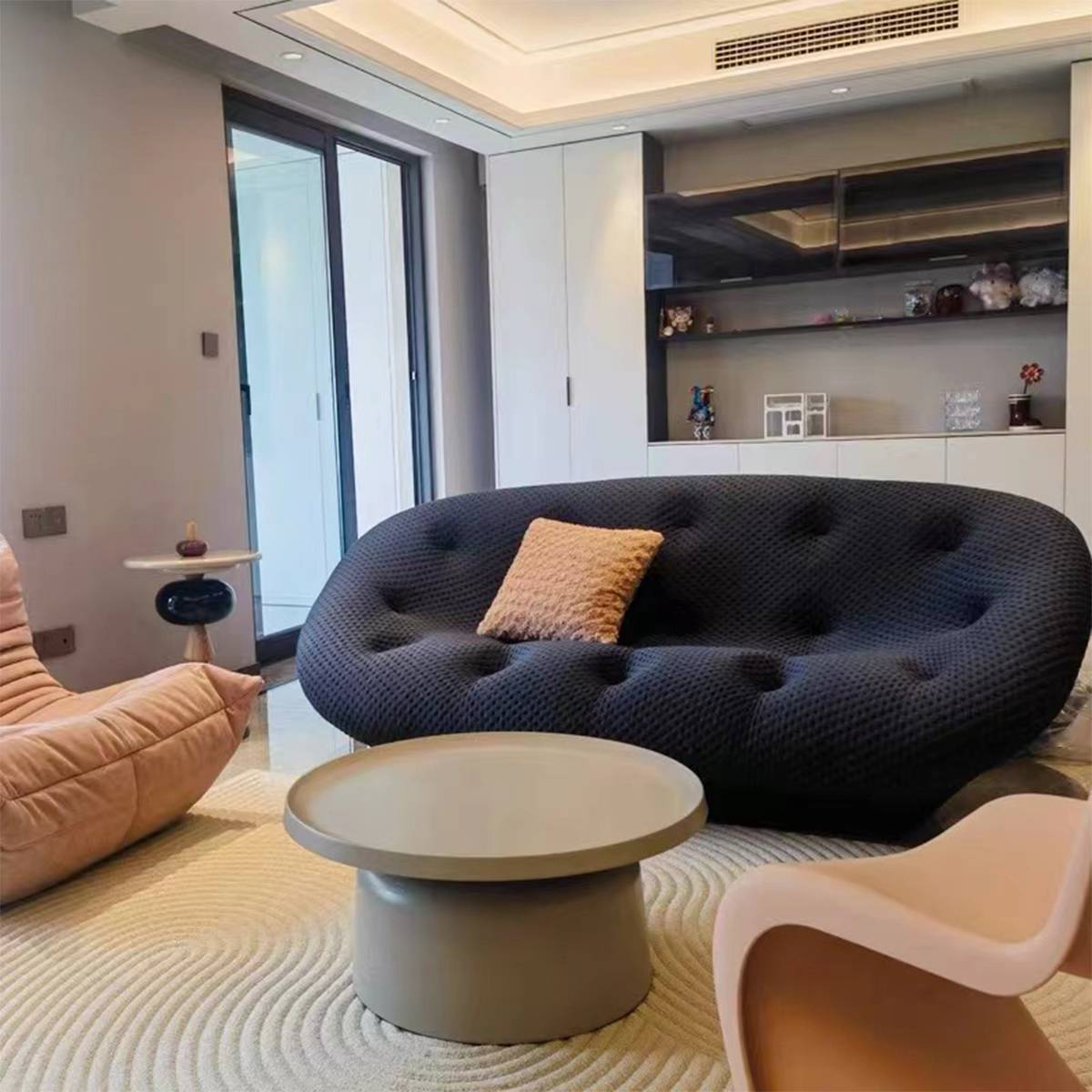 Dark grey shell sofa in a contemporary living room setting
