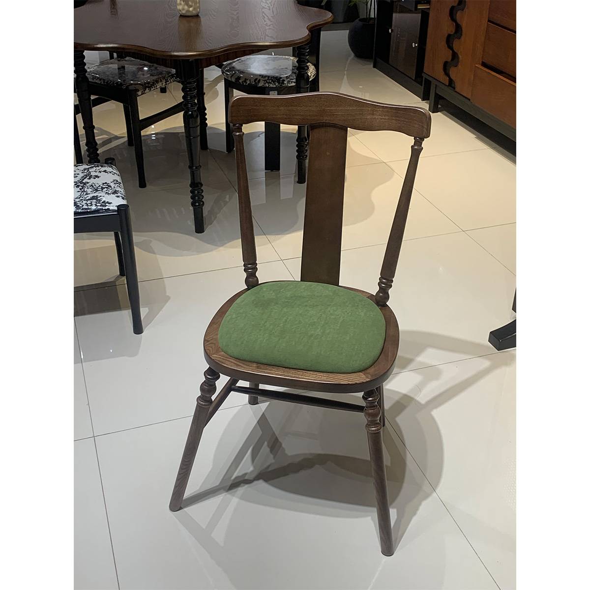 Walnut finish mid-century dining chair with green cushion