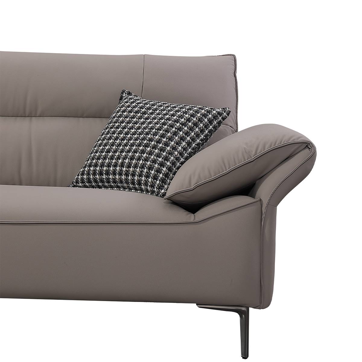 Close-up detail of the grey sofa armrest and patterned pillow
