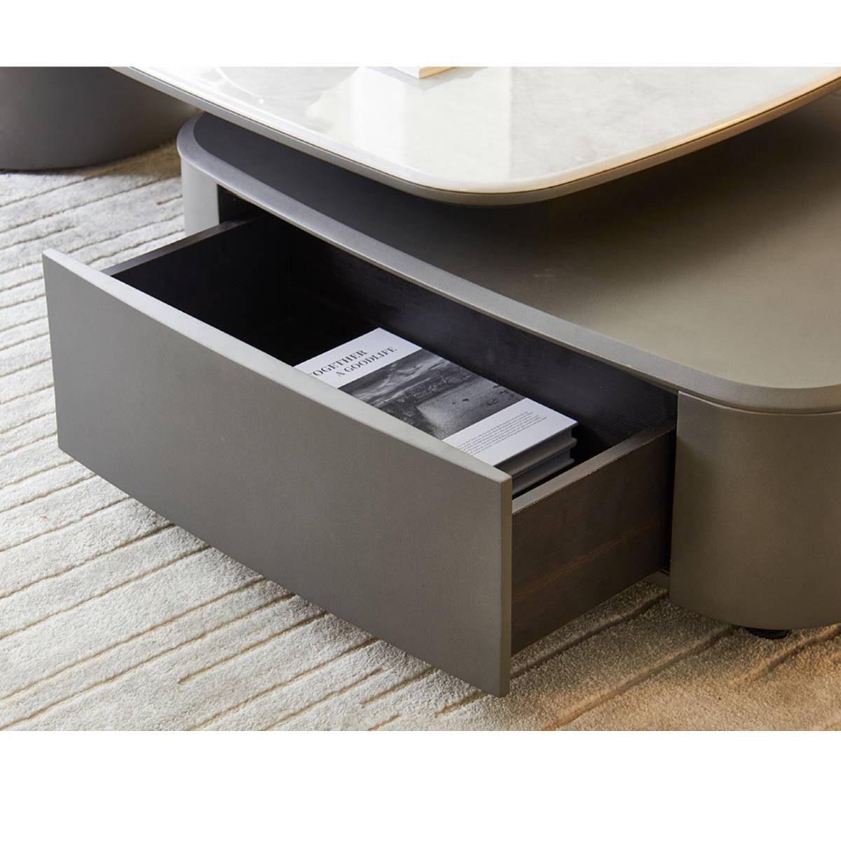 Close-up of the open drawer revealing storage space and a magazine inside.
