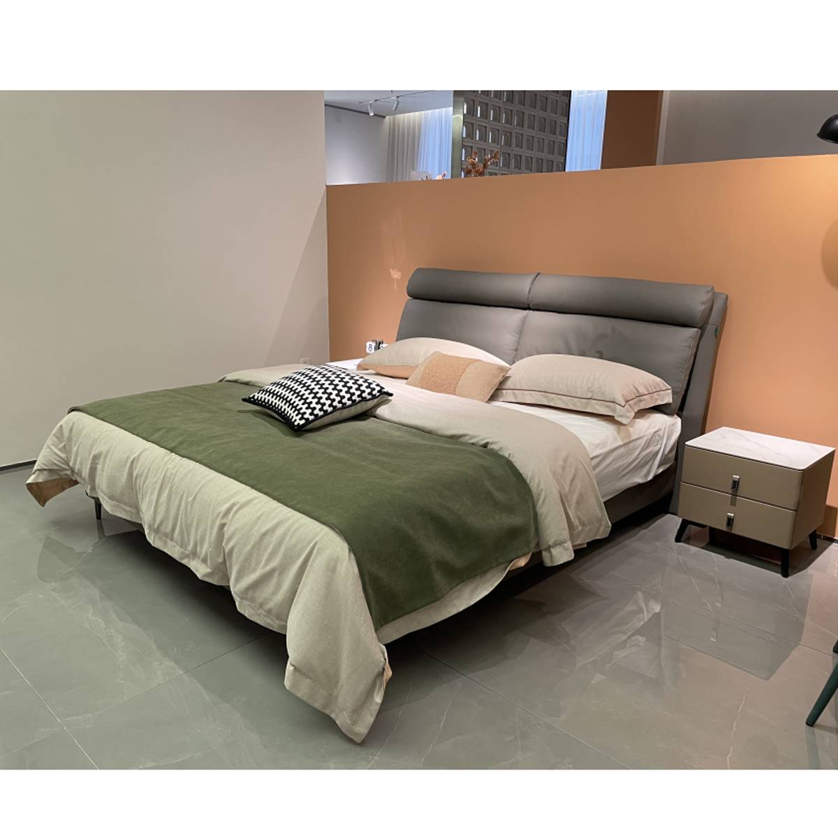 Angled view of the bed showing the headboard and bedding