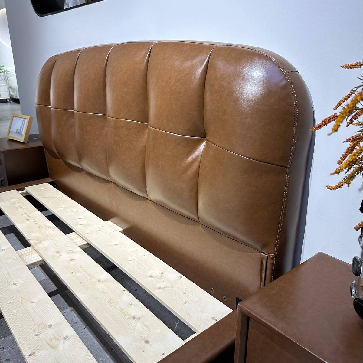 Close-up of the tufted leather headboard