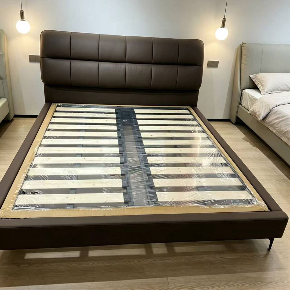 Close-up of the bed frame showing the wooden slat base and headboard