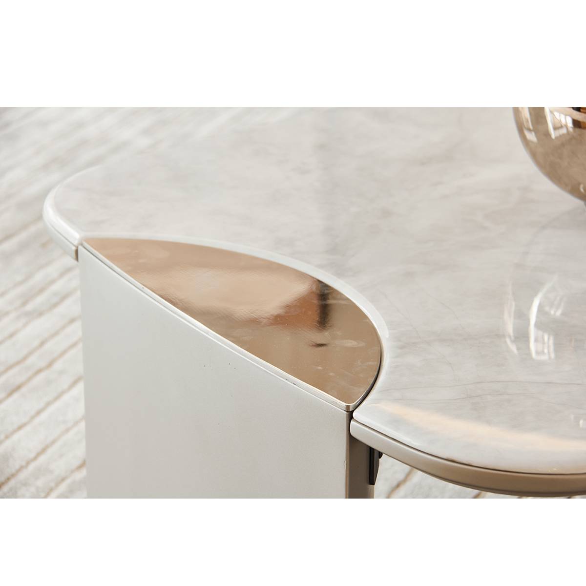Close-up detail of the coffee table showing the curved microcrystalline stone edge and stainless steel trim.