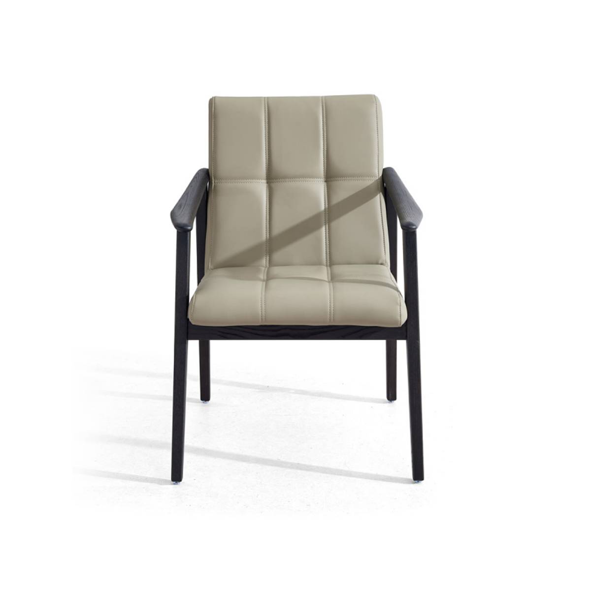 Front view of the beige leather armchair showing tufted back detail