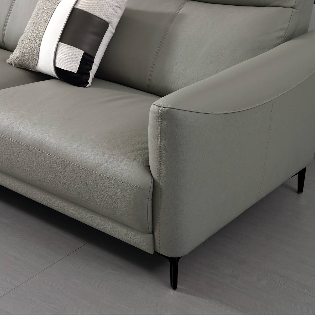 Close-up of the sofa armrest and seat cushion showing leather texture