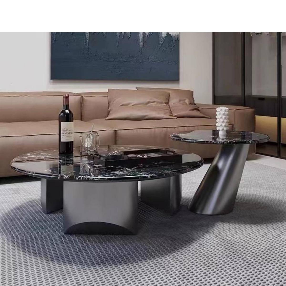 Close-up view of the marble coffee table set with a wine bottle and decorative items on top.