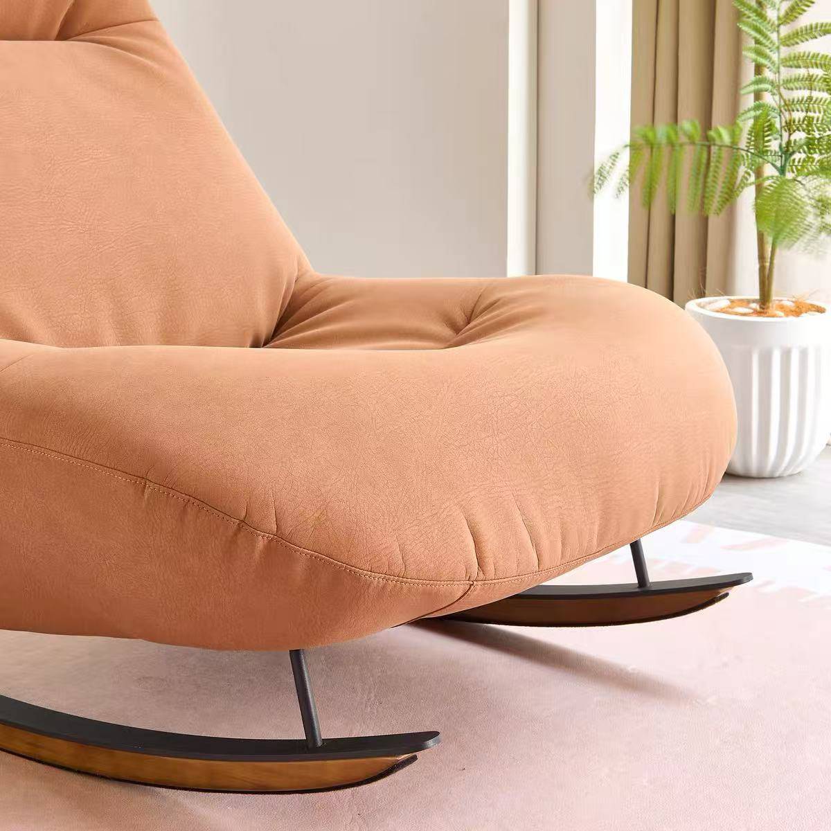 Close-up detail of the chair's upholstery and wooden rocking base