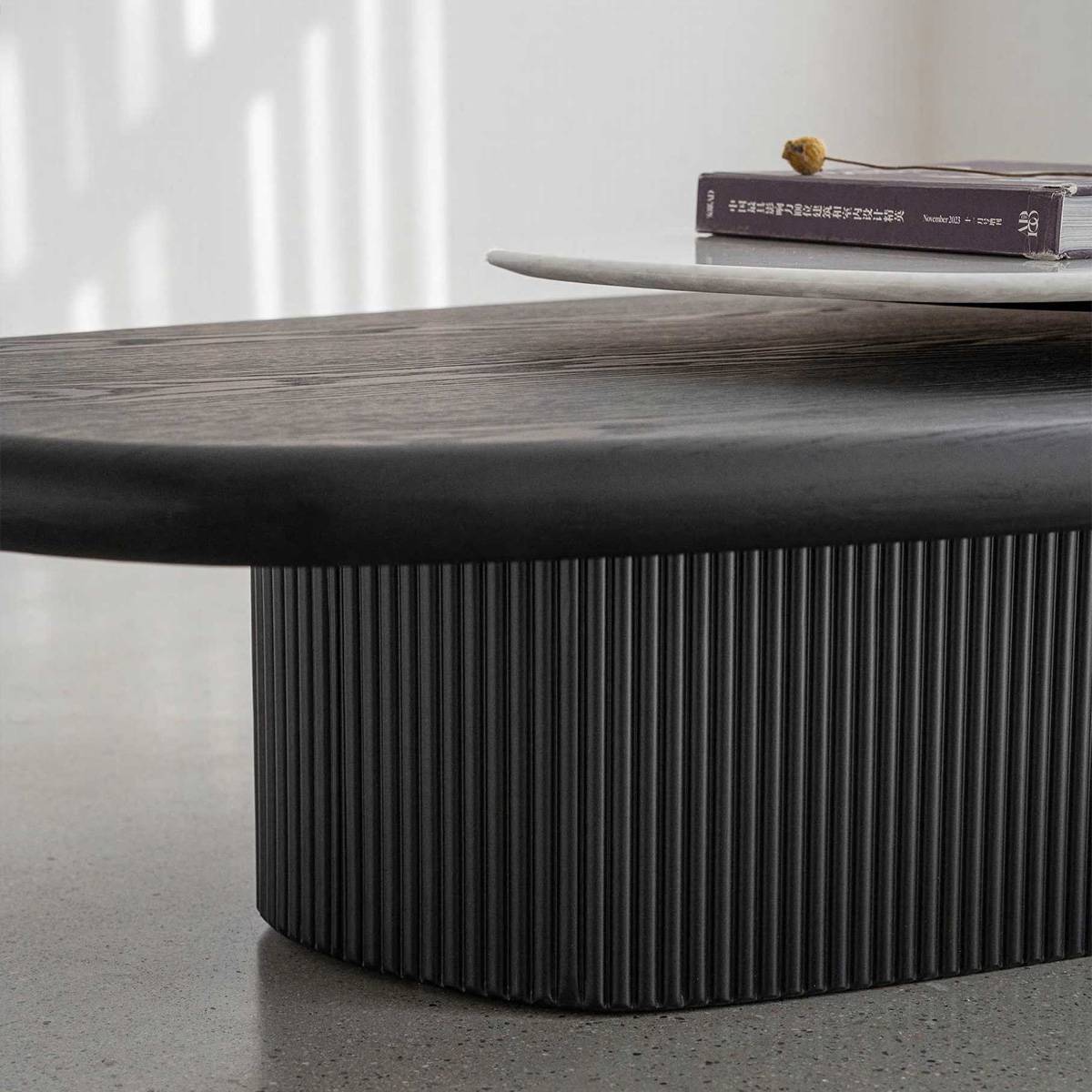 Close-up detail of the fluted base and the edge of the stone top