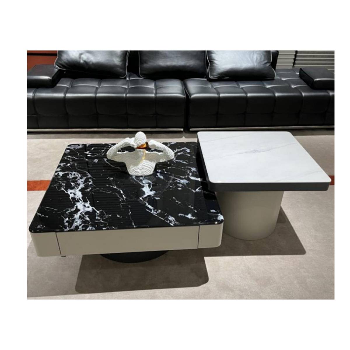 Front view of the coffee table set with black leather sofa background
