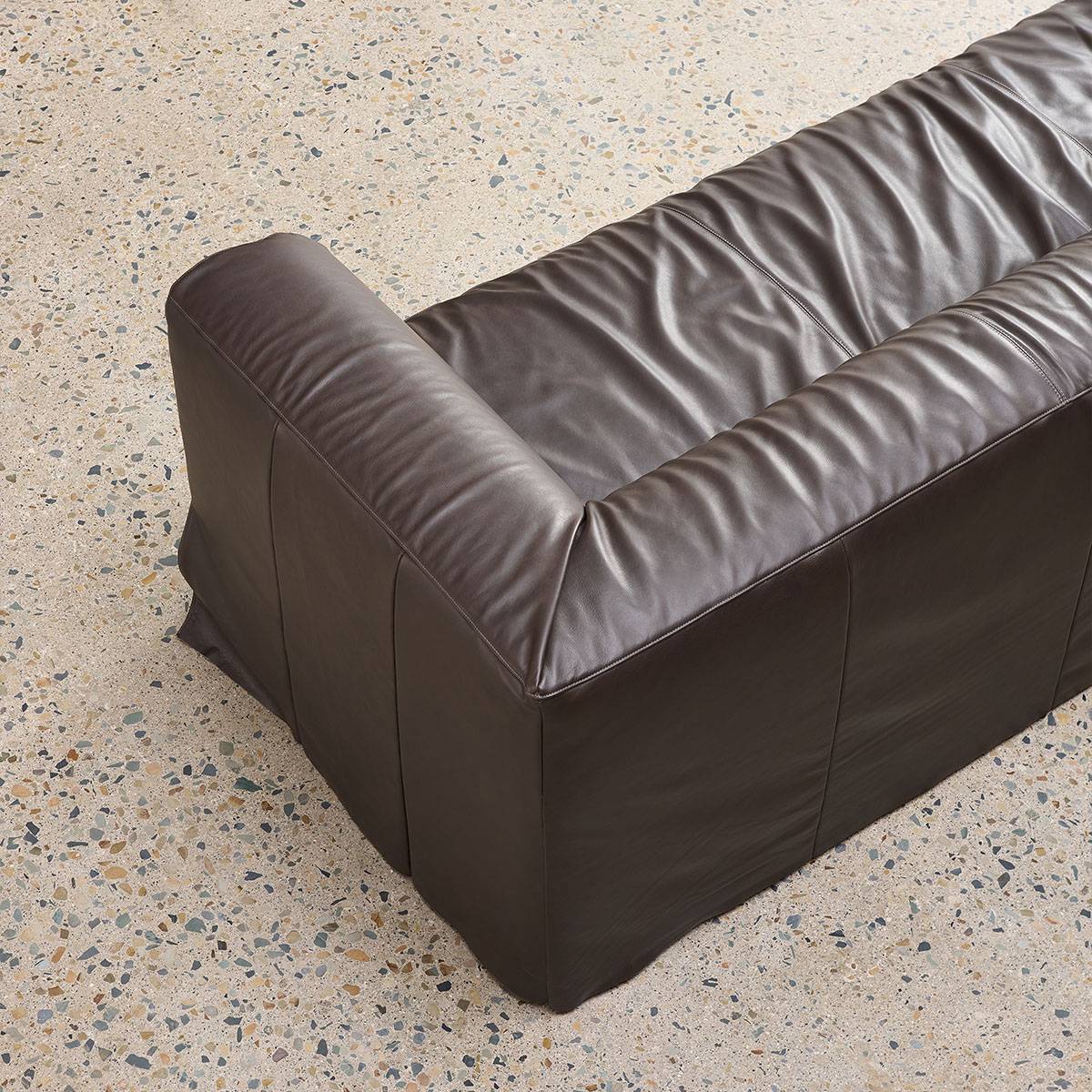Close-up detail of sofa armrest and leather texture