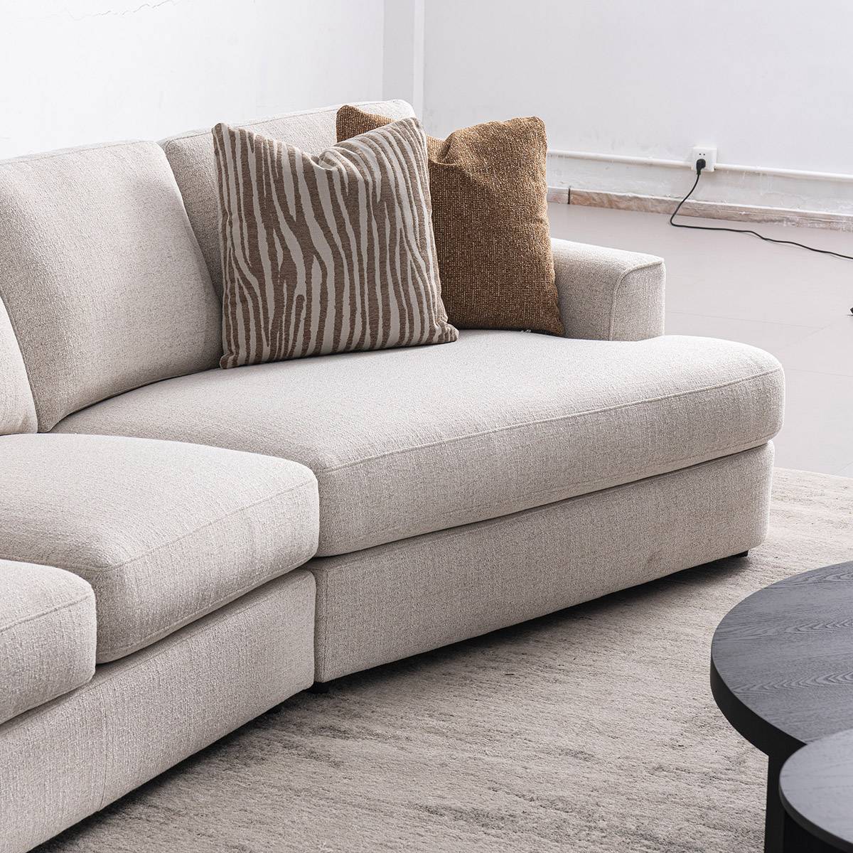 Side angle view of the sofa showing the chaise section and throw pillows