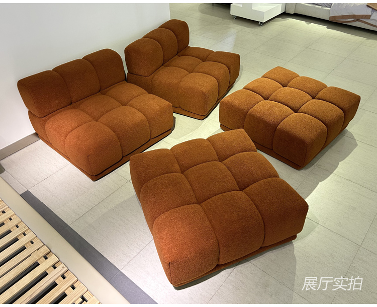 Disassembled modular sofa components showing individual seat and ottoman units