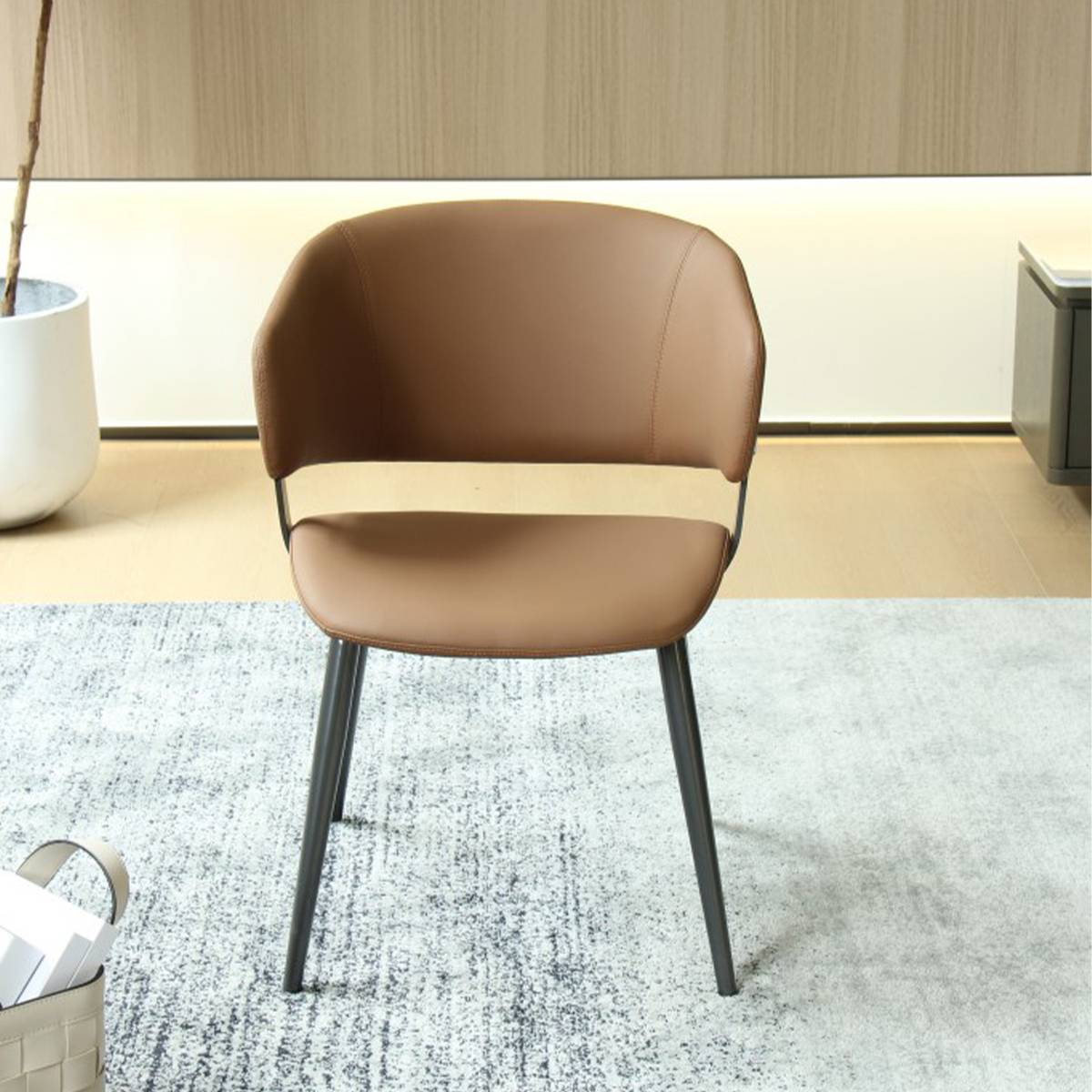 Front view of the orange dining chair showing the curved backrest