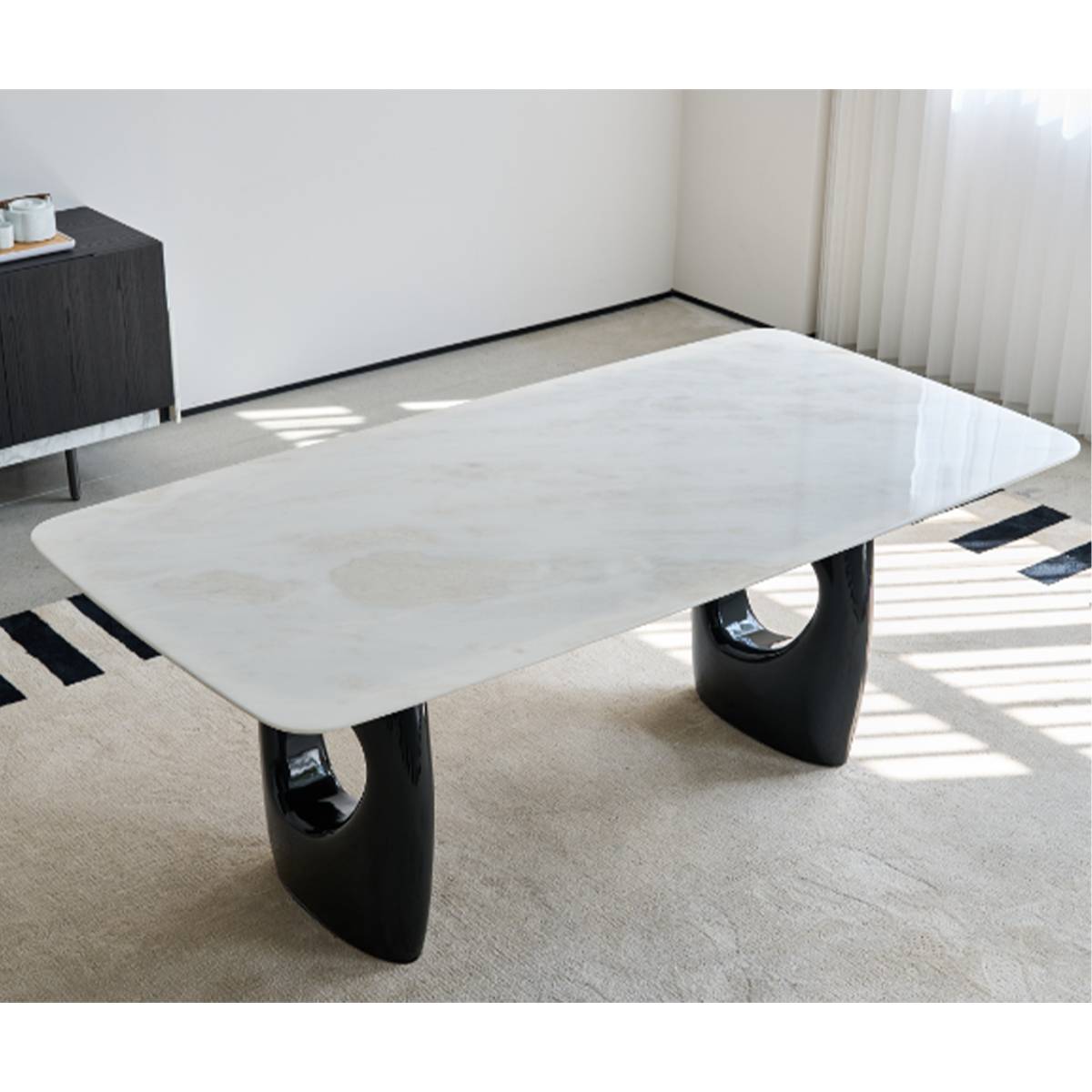 Close-up view of the white stone dining table top and sculptural legs