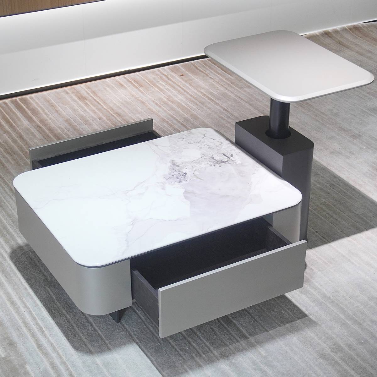 Close-up of the coffee table with the drawer open, showing storage space.
