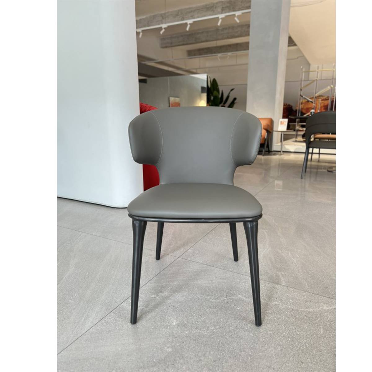 Dark grey dining chair in a showroom setting