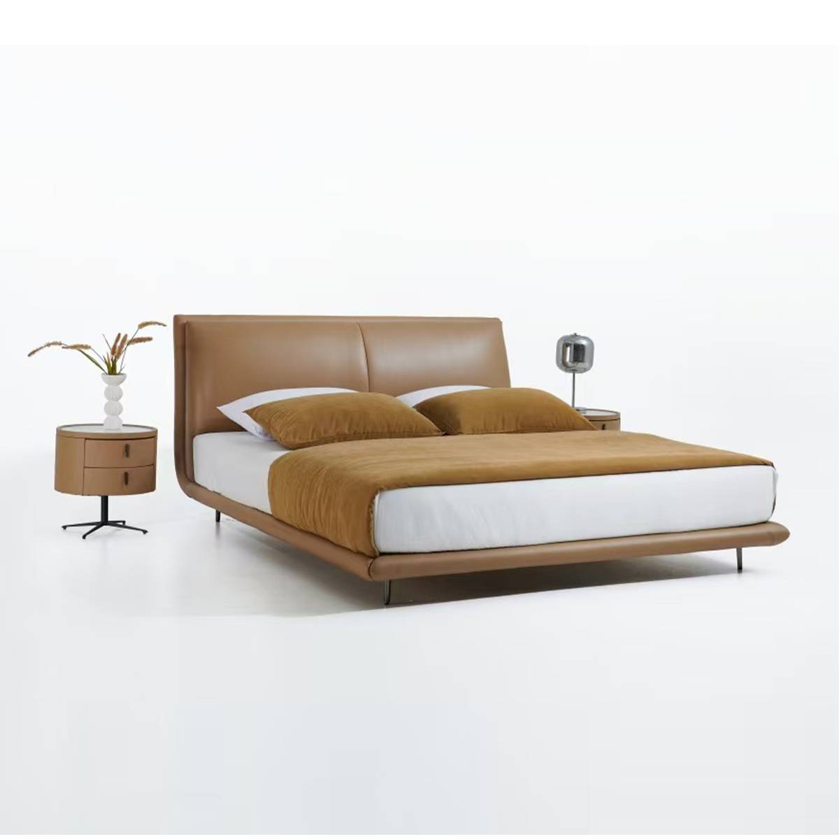Full view of the brown leather soft bed with white bedding and brown throw