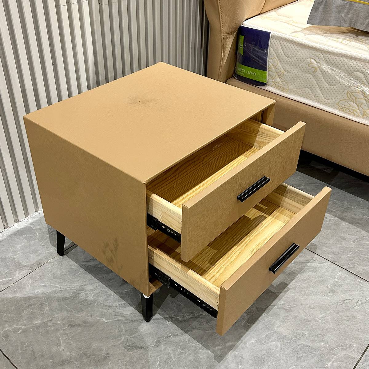 Top-down view of the bedside cabinet with drawers open, revealing the wooden interior and slide mechanism