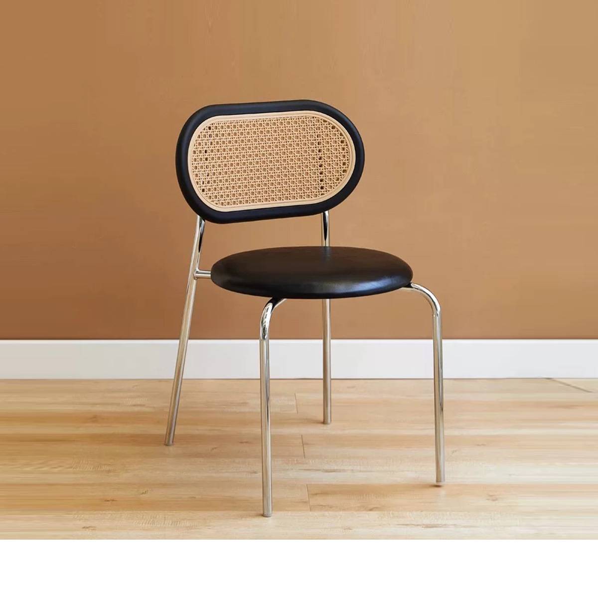 Black mid-century dining chair with metal legs and rattan backrest