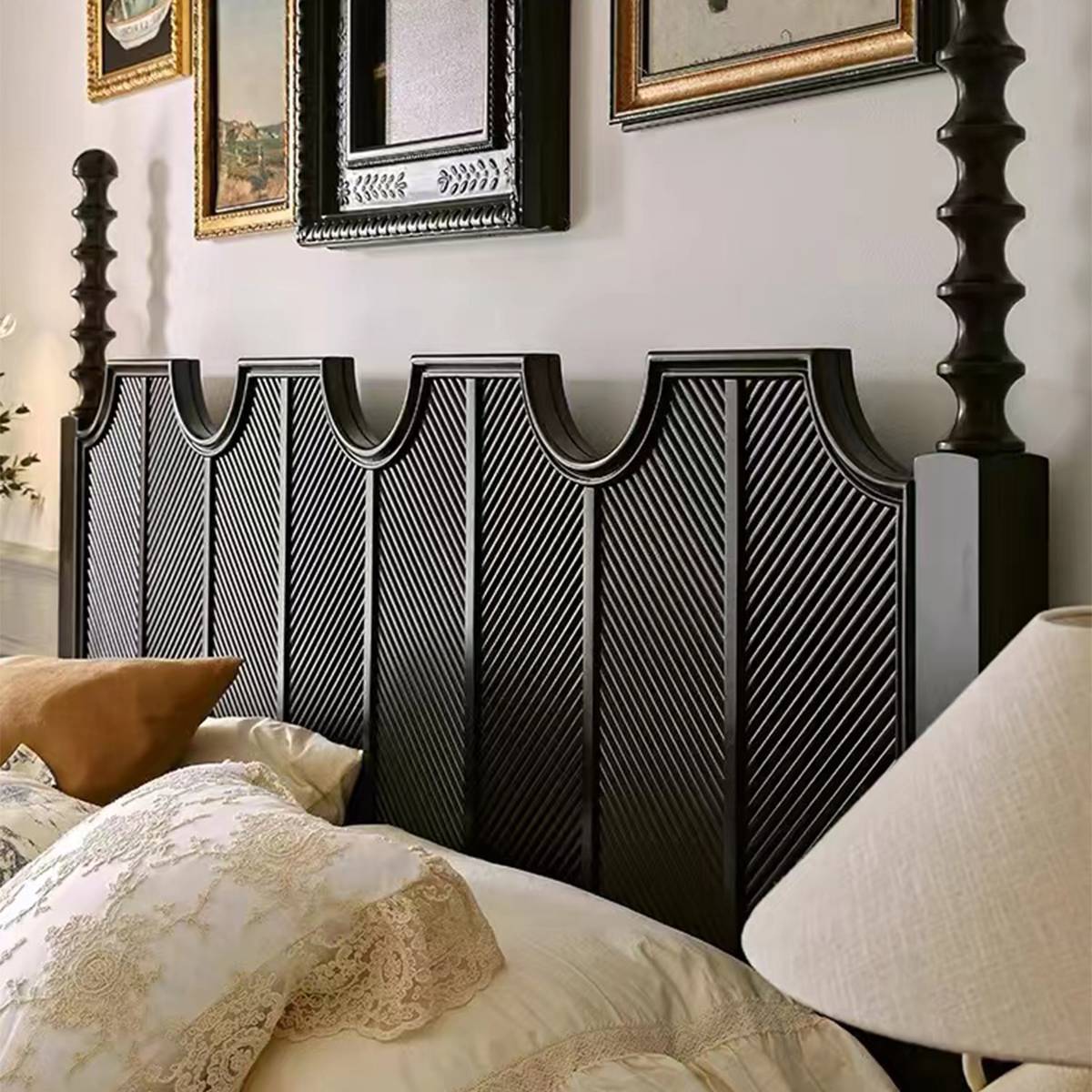 Close-up of the black carved headboard and turned post