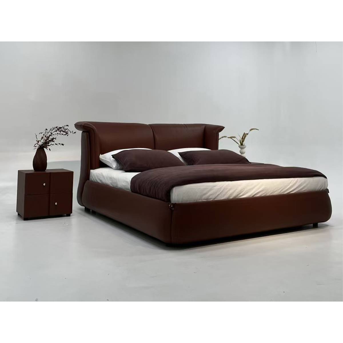 Side view of the brown leather bed with matching bedside table
