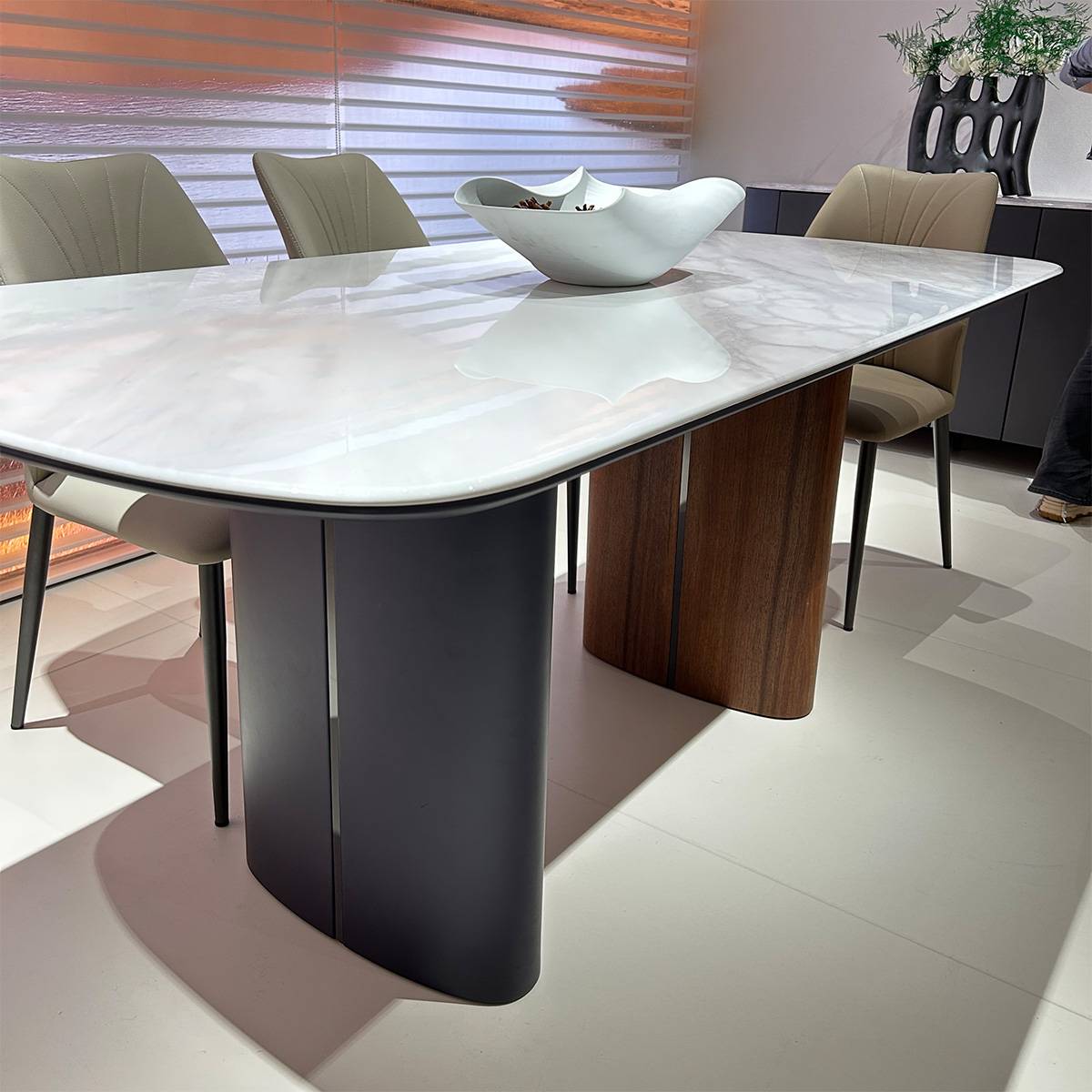 Close-up of the table base showing the black and walnut wood grain details