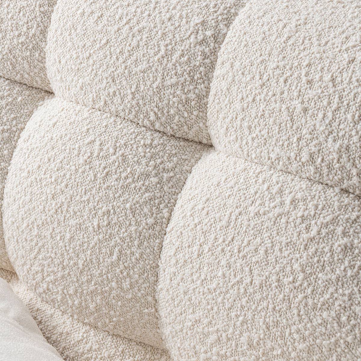 Close-up of the tufted fabric texture on the bed frame