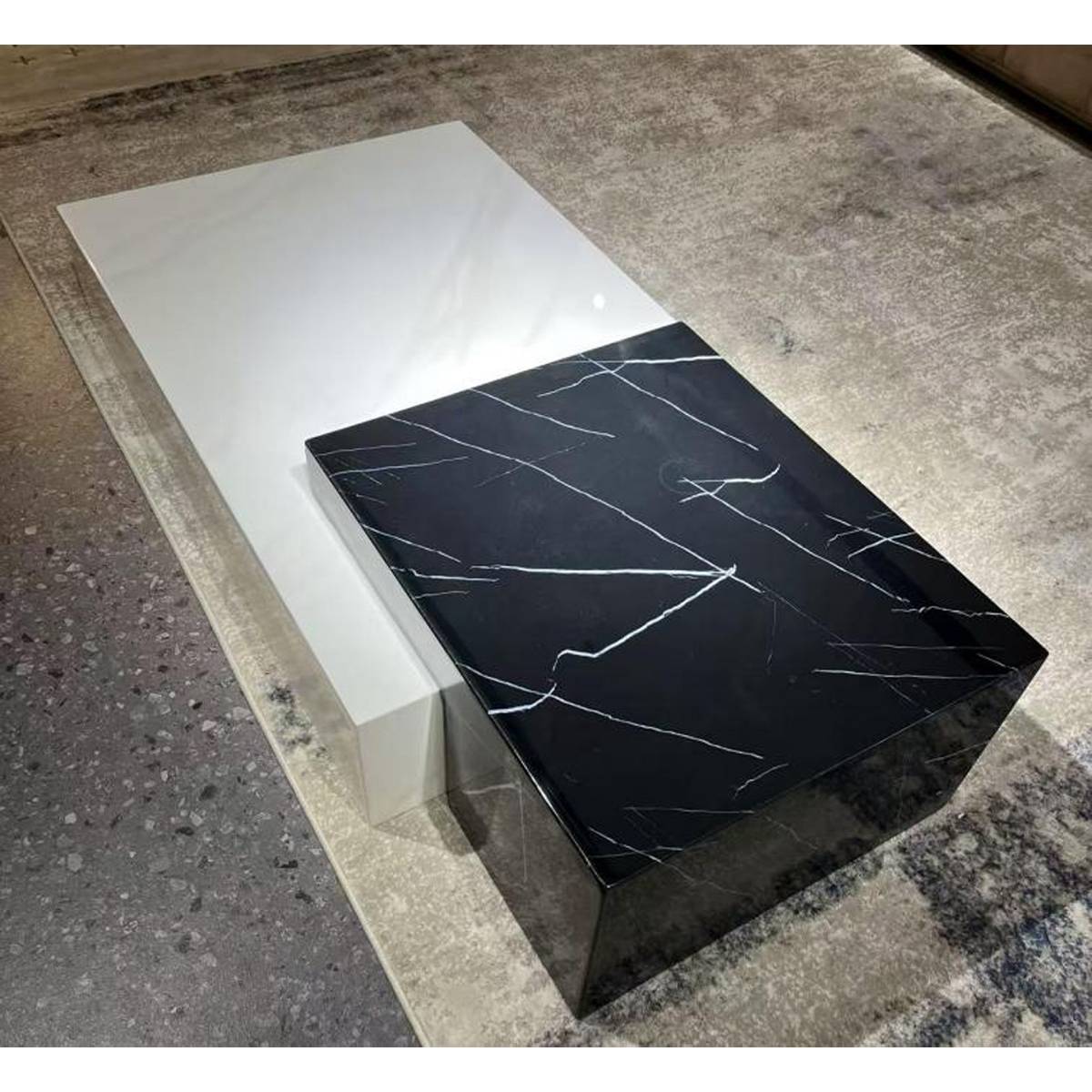 Close-up view of the marble coffee table showing the texture and finish.