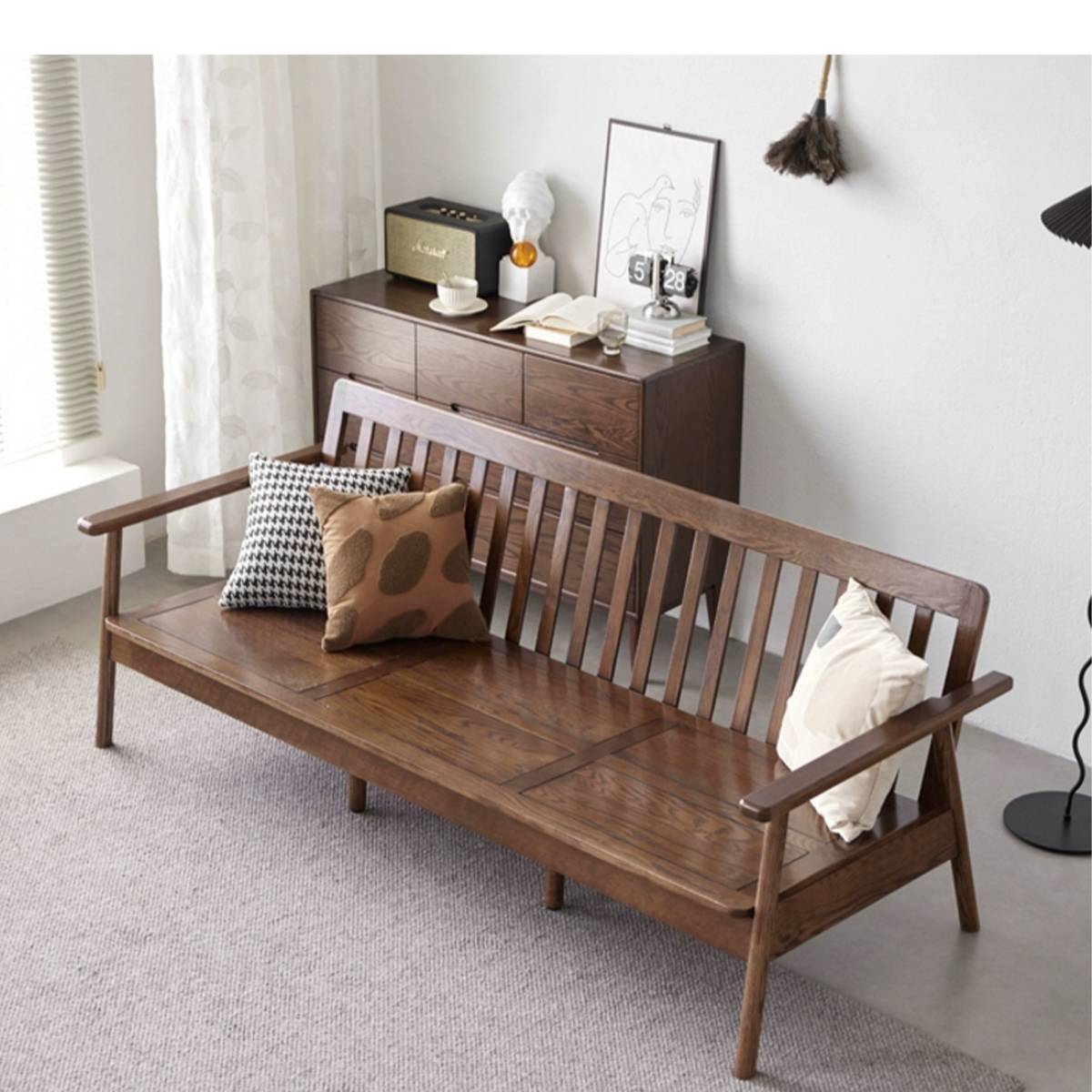 Dark walnut finish version of the slat sofa with patterned pillows