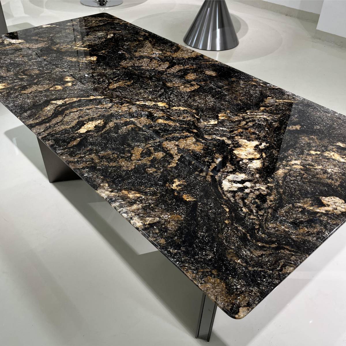 Close-up detail of the black and gold veined marble tabletop texture