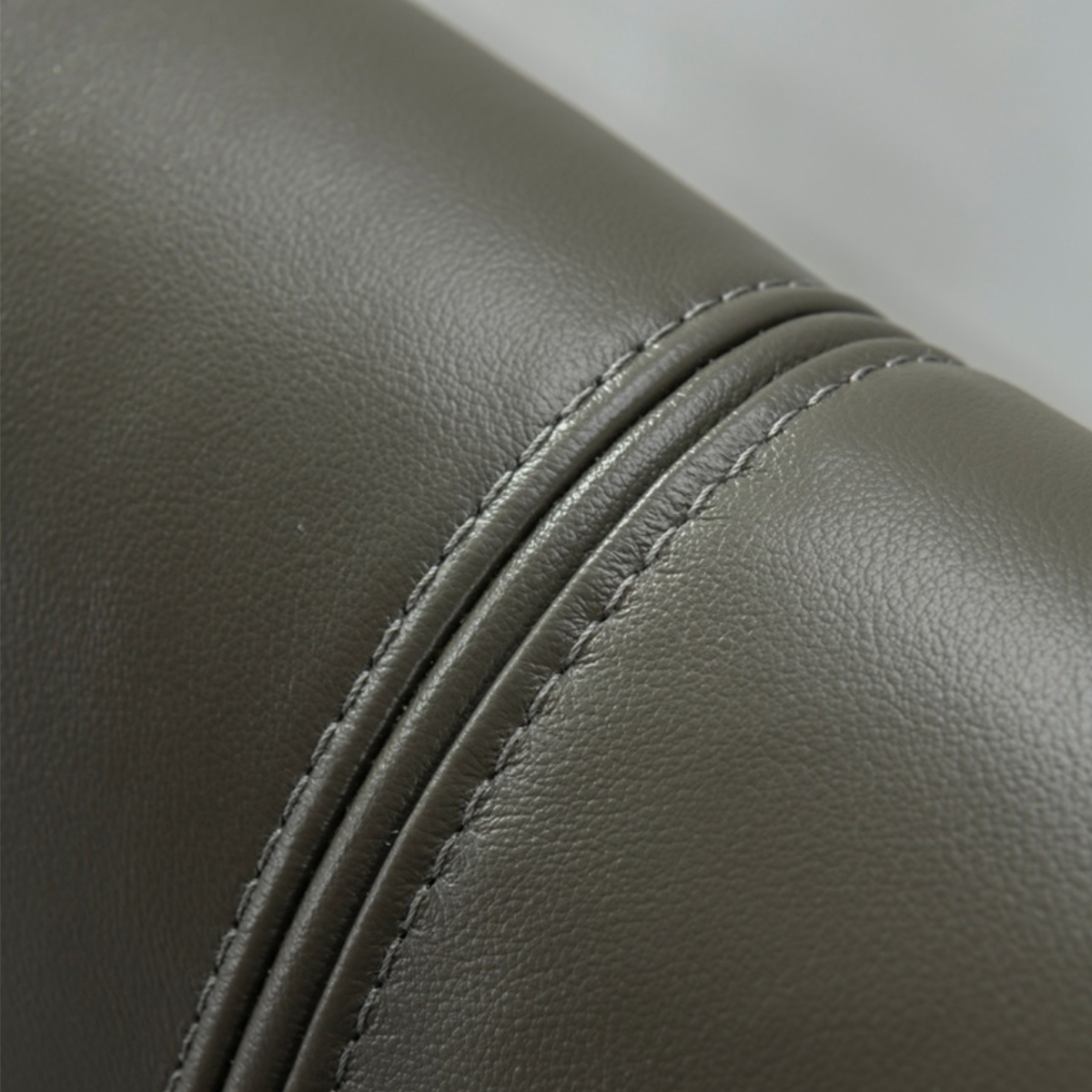 Detail shot of the leather texture and stitching on the headboard