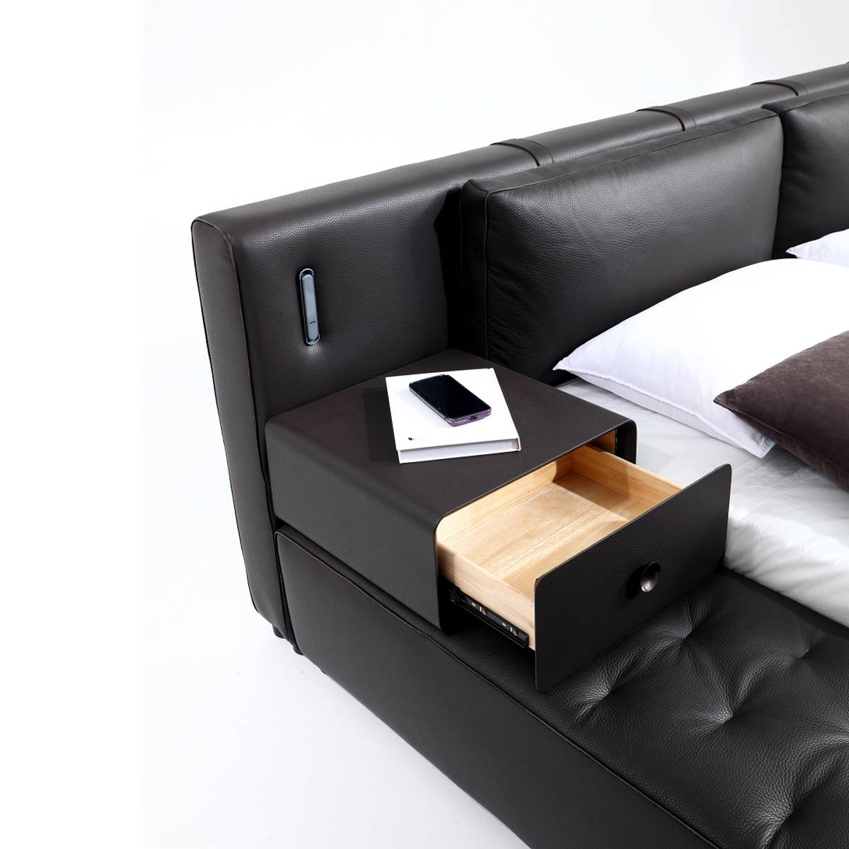 Close-up of the integrated bedside cabinet with an open drawer showing wooden interior