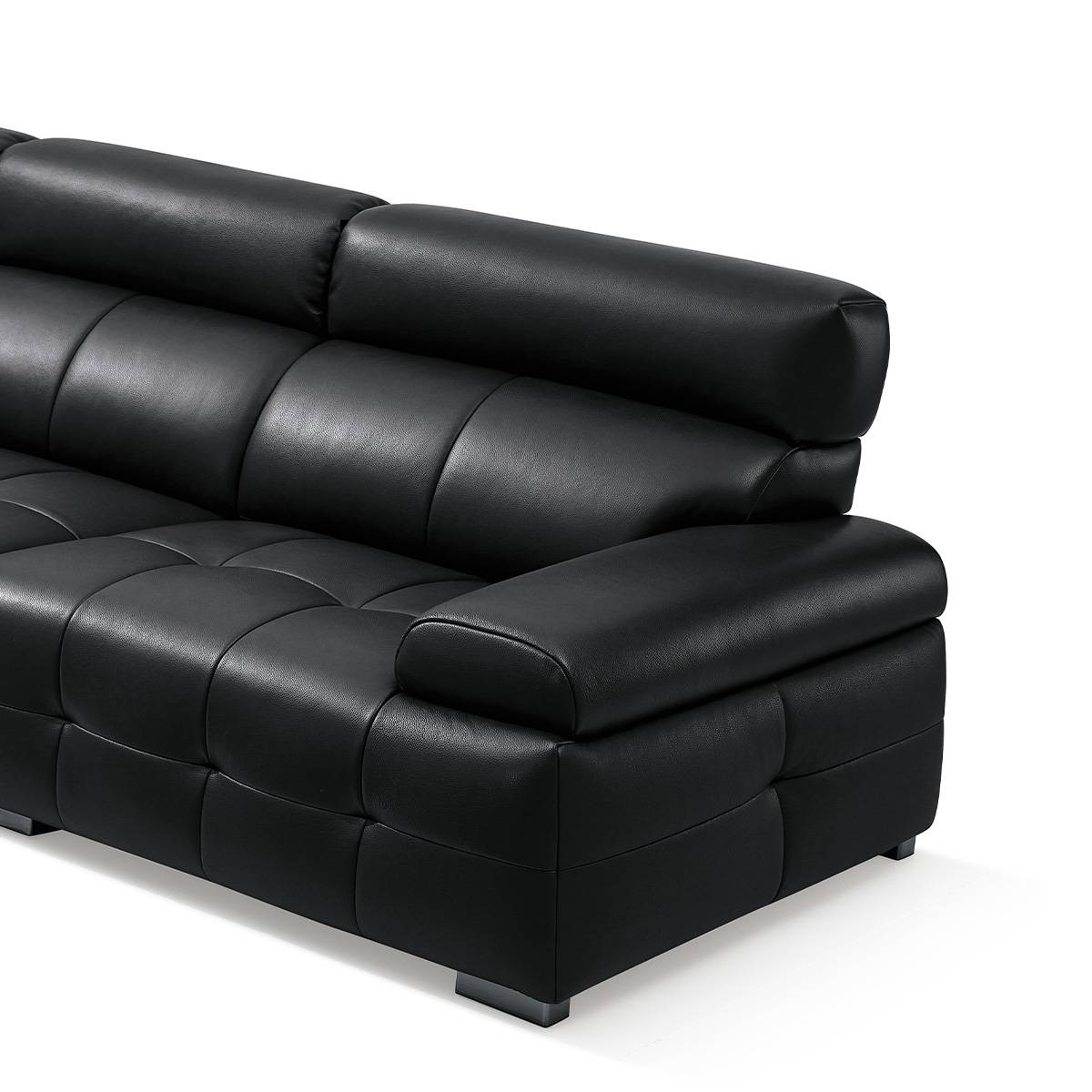 Close-up detail of the black leather sofa armrest and seat cushion texture