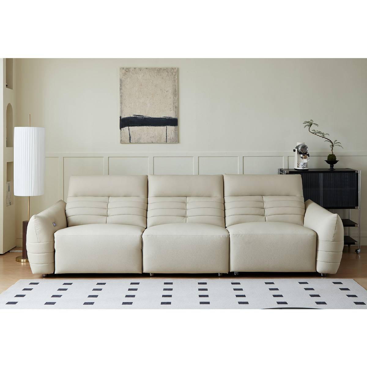 Straight-on view of the beige leather sofa showing the three-seat configuration