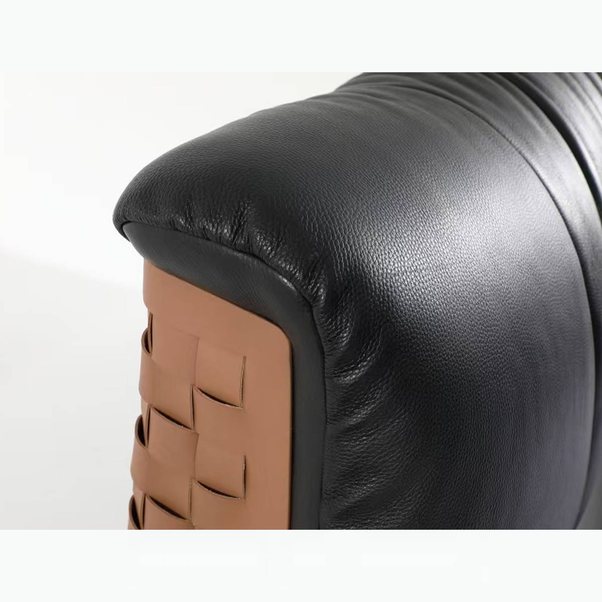 Close-up of the vertical tufting on the black leather headboard