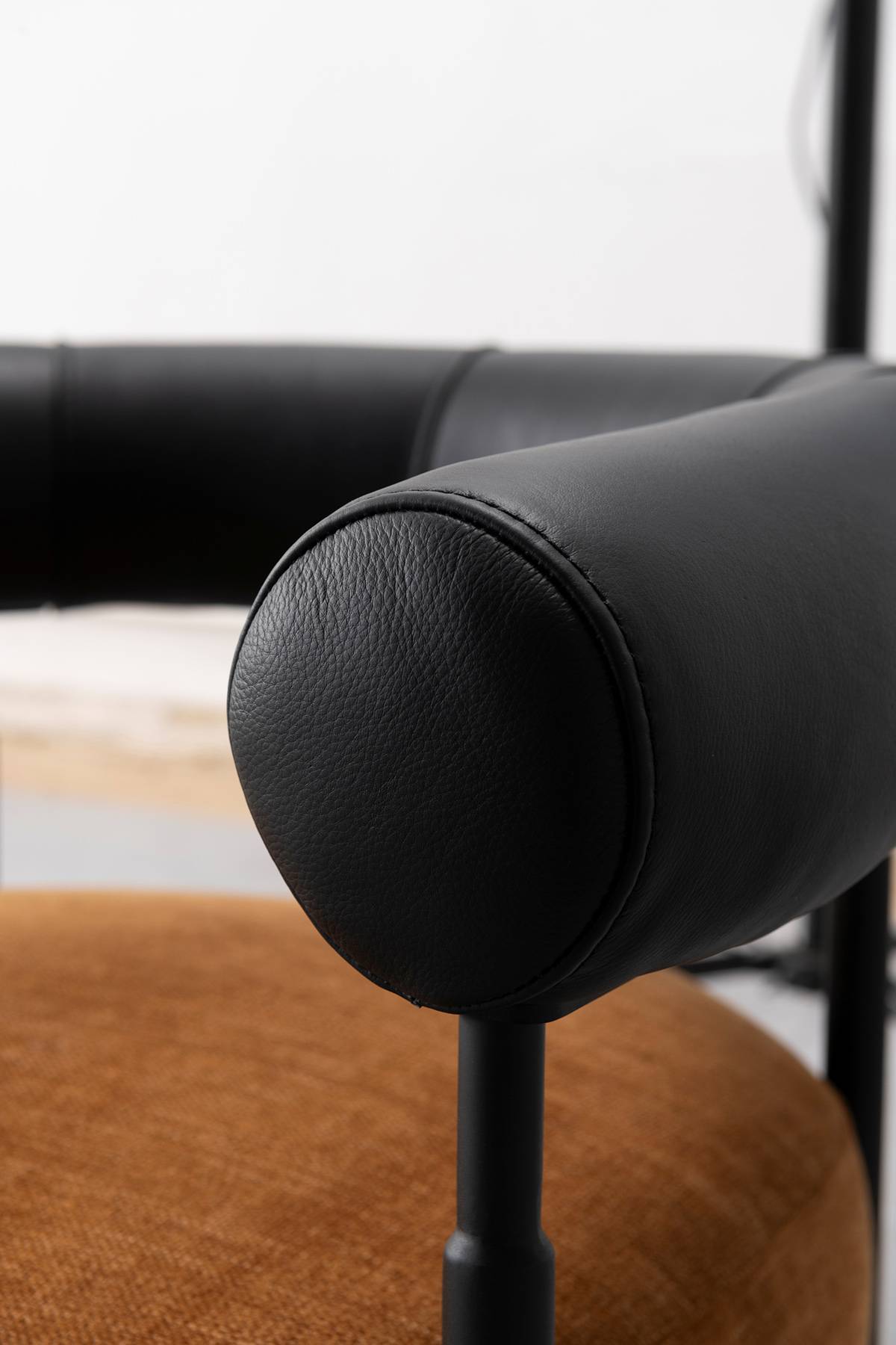 Detail of the rounded end of the black leather armrest