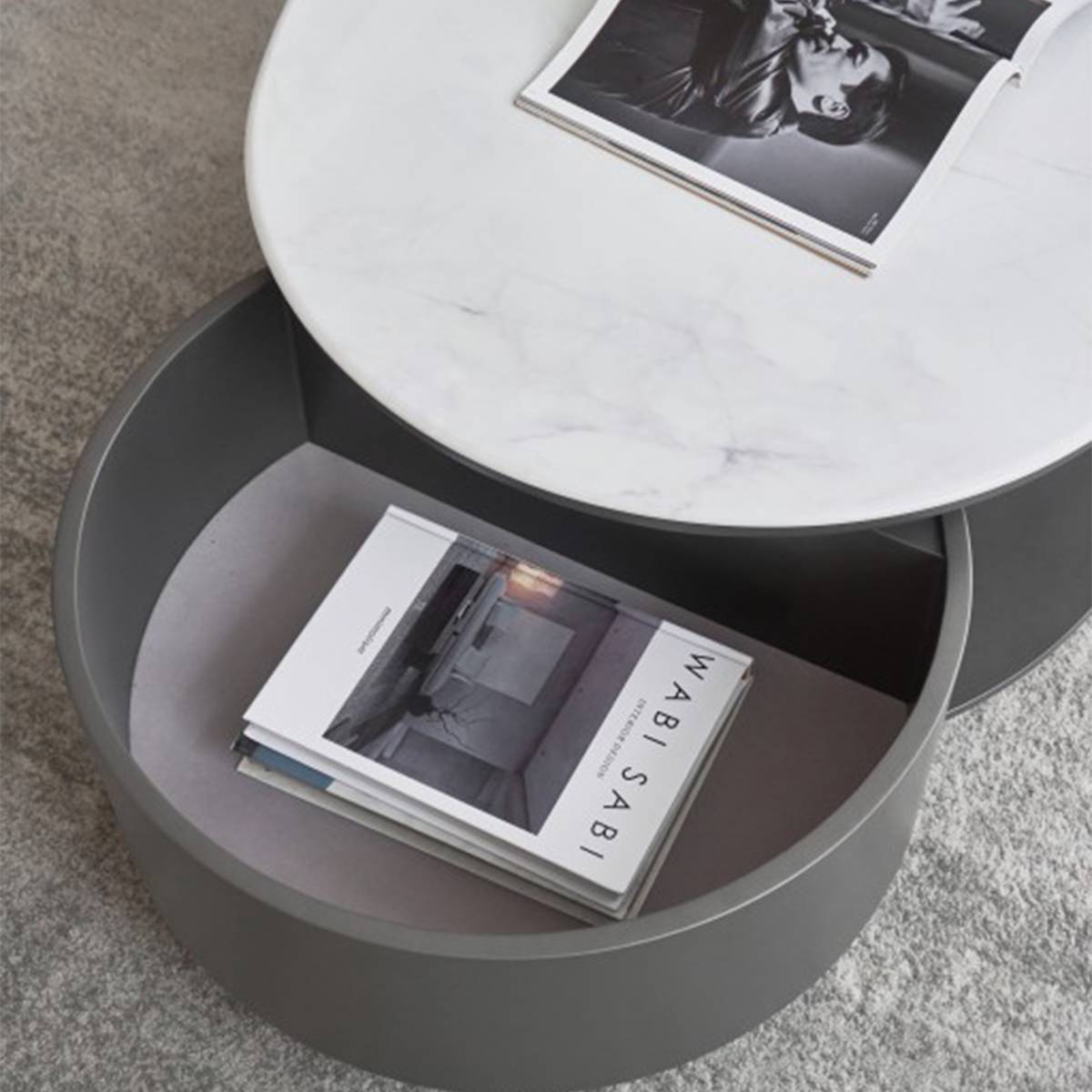 View of the lower storage shelf containing a magazine titled 'WABI SABI'