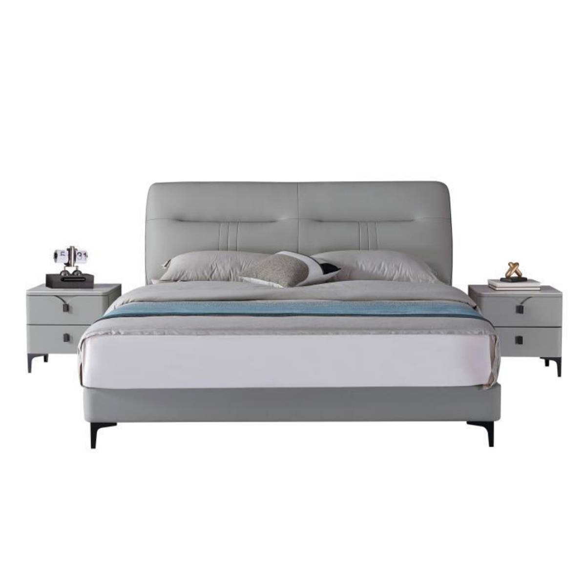 Front view of the grey leather bed with matching bedside tables