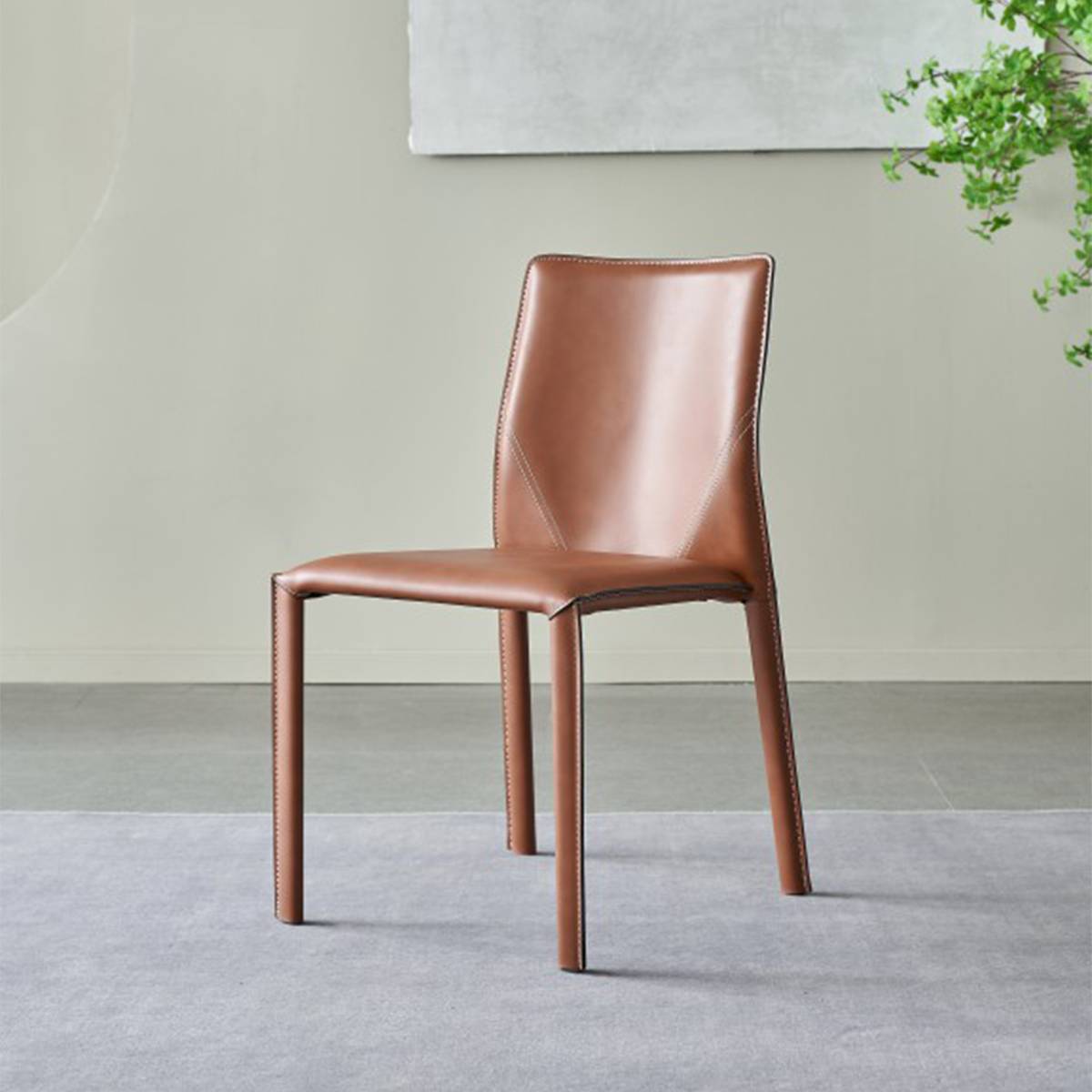 Full view of the orange saddle leather dining chair